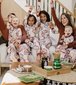 Load image into Gallery viewer, Family sitting on the couch celebrating while wearing Burt&#39;s Bees Baby matching football pajamas
