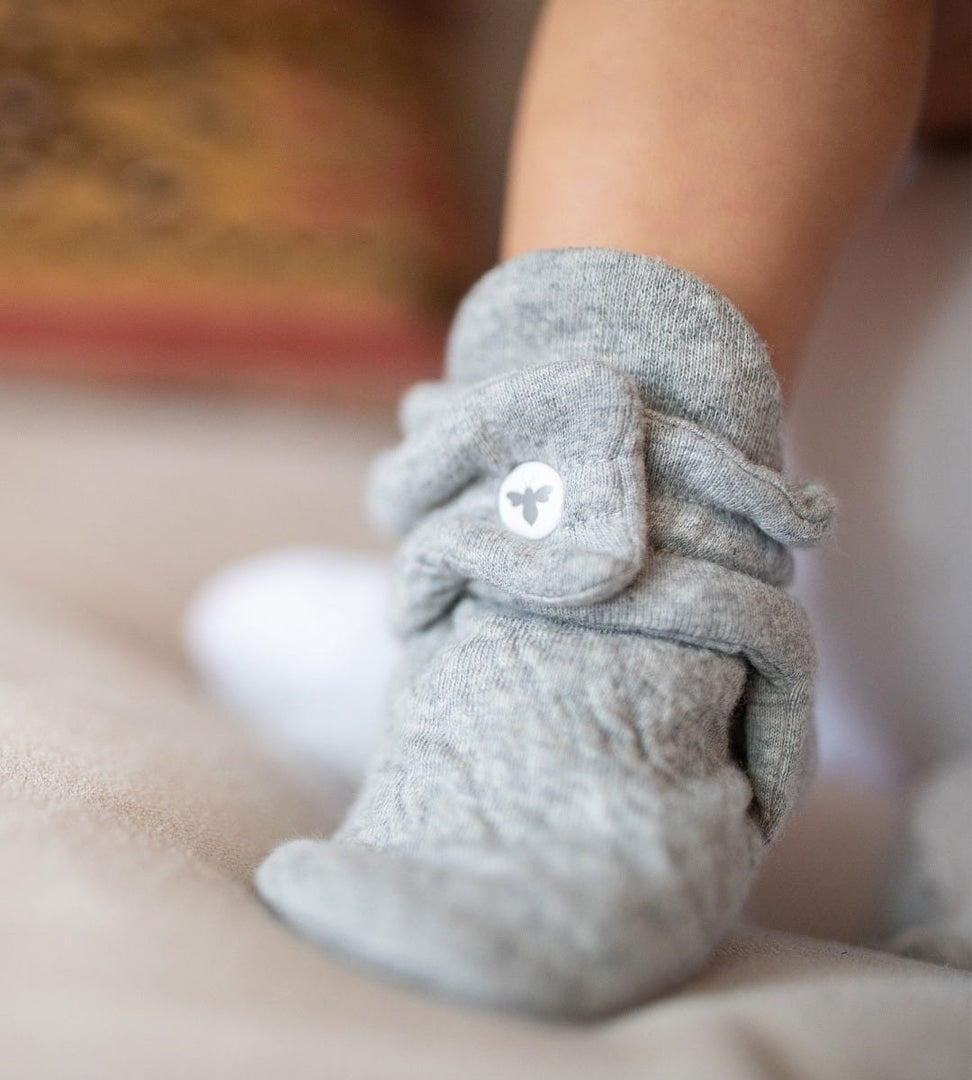 Close up of infant wearing Quilted Bee Organic Baby Booties