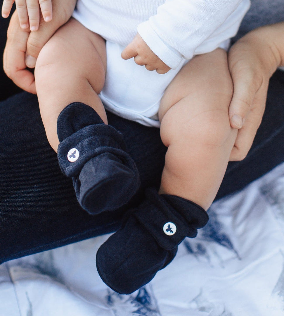 Newborn wearing Solid Adjustable Organic Baby Booties Midnight